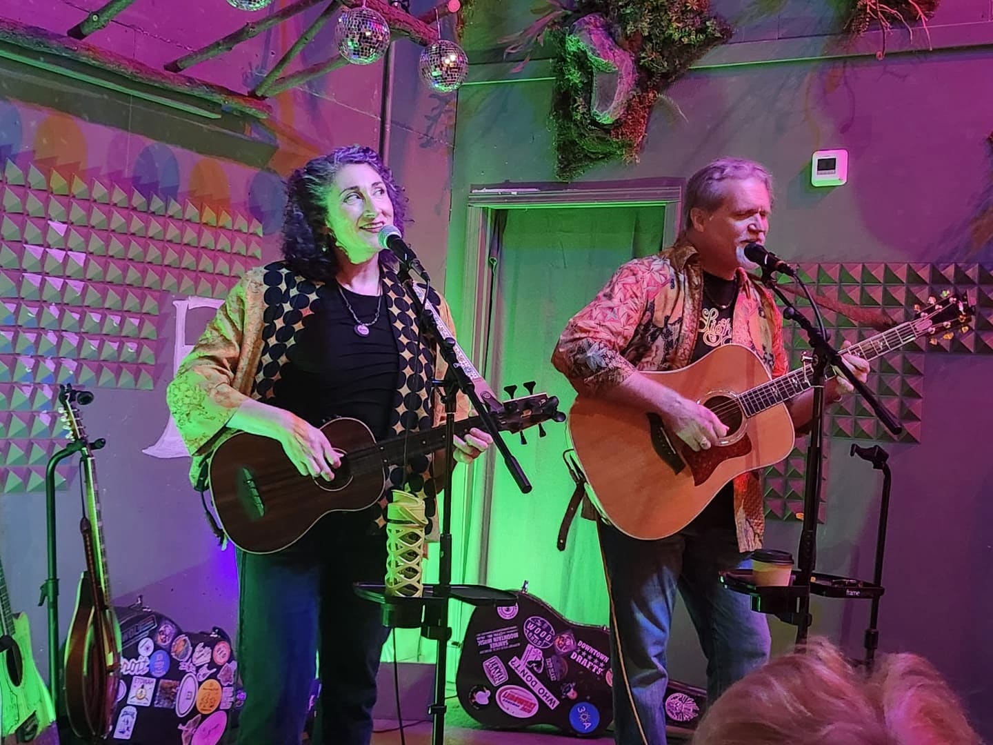 The duo playing live under disco balls and colored lights