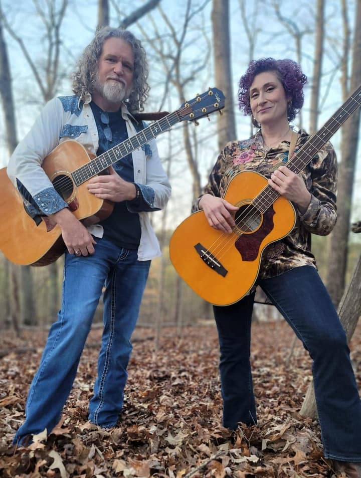 Kristi and Steven in the North Georgia woods, guitars in hand